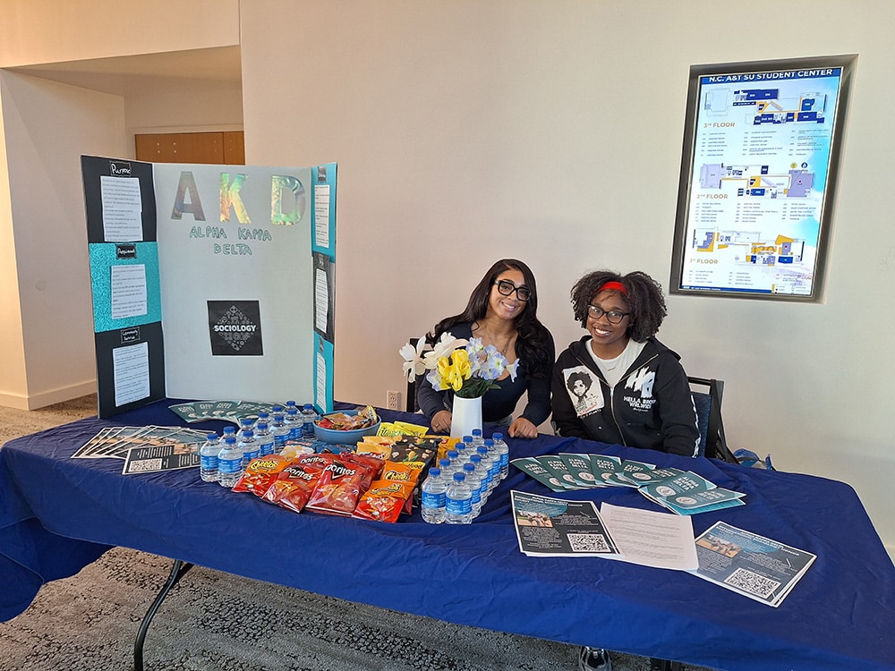 Photo of members of the AKD Zeta Chapter at the student organization showcase.